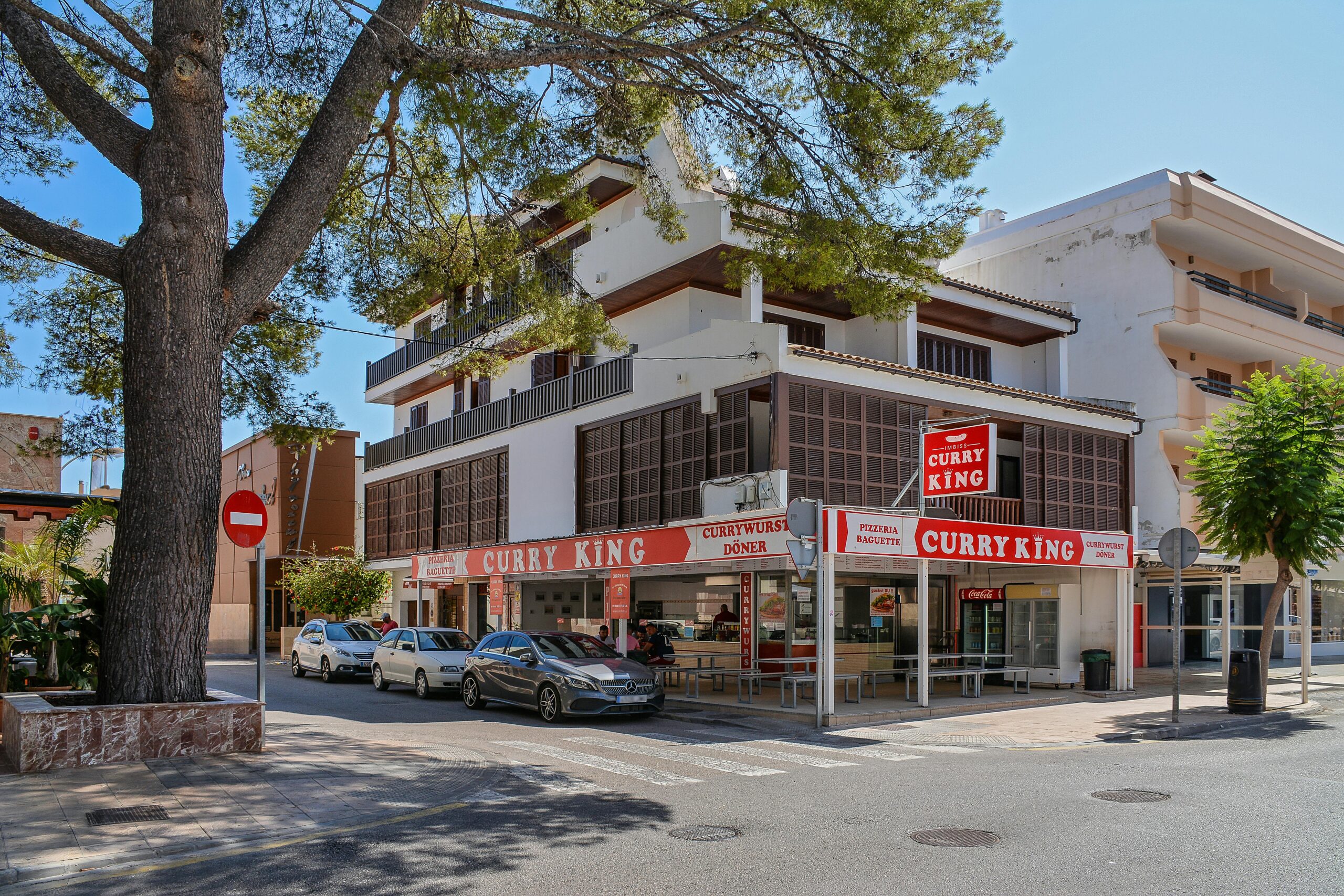 Street view of Curry King restaurant in sunny Cala Rajada, Spain.
