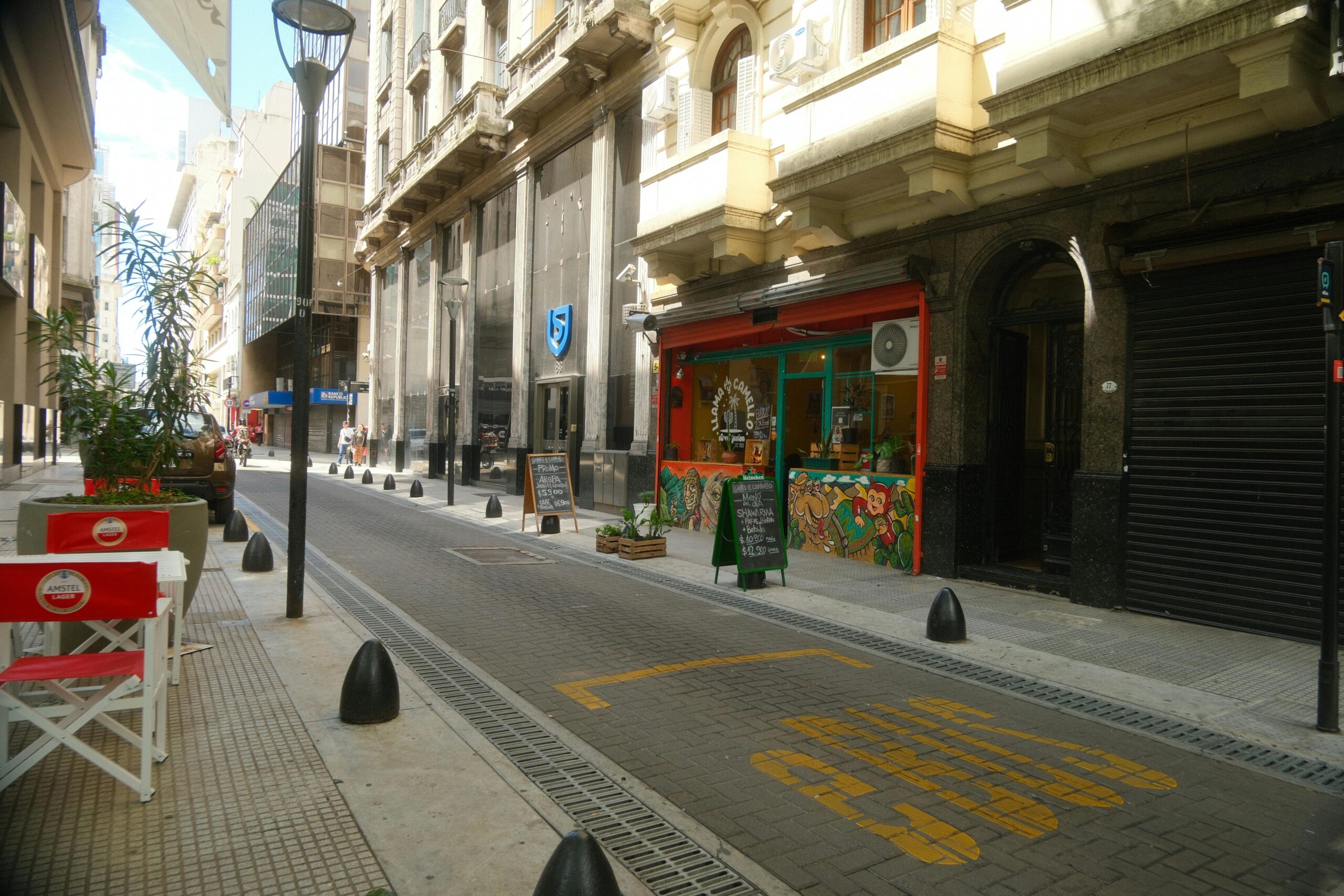 A vibrant street in Buenos Aires with cafes, offering a picturesque city view.